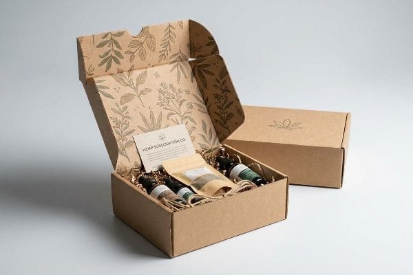 Open Hemp Subscription Box Open custom kraft hemp subscription box, botanical print, three tinctures, pouch, and 'Hemp Subscription Co.' card.