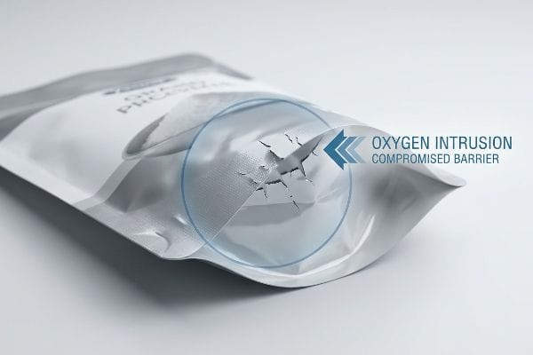 Silver flexible pouch with a visible micro-fracture, highlighting Oxygen Intrusion, Compromised Barrier.
