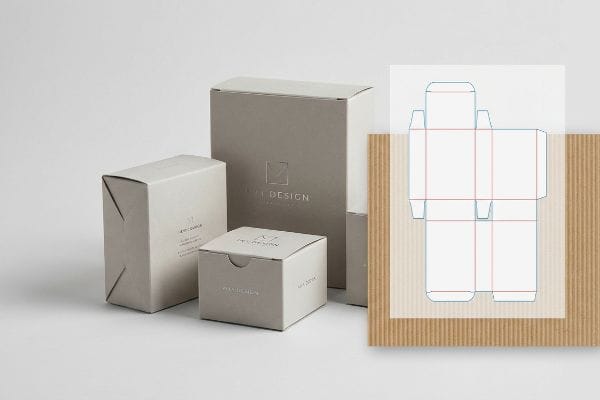 Packaging Dieline Boxes Light grey 'M Design' packaging boxes displayed with a white die-cut structural template and corrugated board.