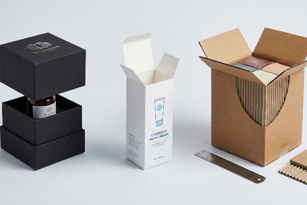Rigid Folding Corrugated Boxes Black rigid box with gold logo and amber bottle, white folding carton for Cosmetic Skin Cream, and brown corrugated box with fluted inserts.