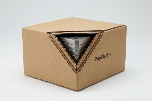 PopDisplay Box Weights Brown corrugated PopDisplay box, partially open, revealing stacked metallic triangular weights for structural integrity.