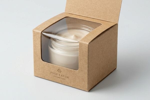 Kraft paperboard cosmetic box with a wood-pulp cellulose window displaying a Pure Earth Cosmetics cream jar.