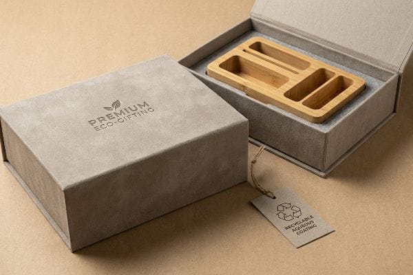 Premium Eco-Gifting Box Soft-touch grey Premium Eco-Gifting box, open to a bamboo organizer, with a Recyclable Aqueous Coating tag.