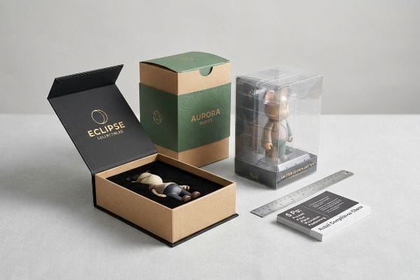 Eclipse Collectibles magnetic box, Aurora Series kraft packaging, and clear plastic Limited-Edition Art Toy box, alongside a ruler and Retail Compliance Check cards.