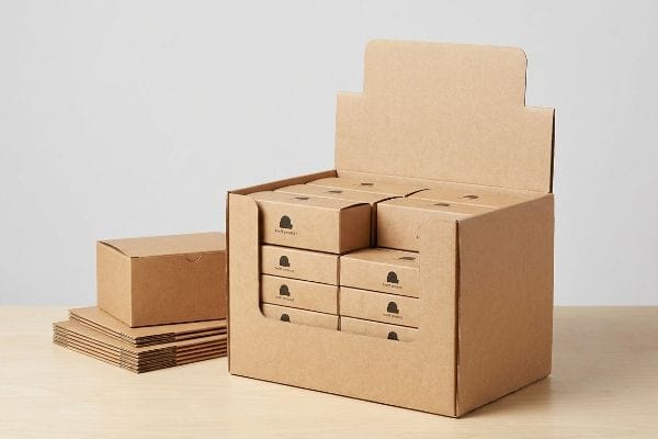 Corrugated kraft display box filled with 'Earth product' boxes, alongside flat-packed kraft packaging, ready for retail visibility.