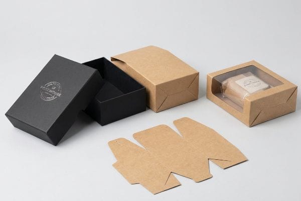 Diverse Carton Packaging Black Post House rigid setup box, kraft folding cartons, and a windowed carton with Fresh Soap, showing carton packaging types.