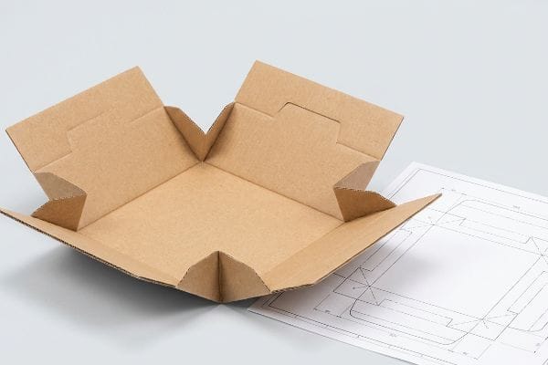 Snap Lock Bottom Dieline Partially assembled brown kraft cardboard snap lock bottom box with its structural dieline, highlighting the multi-flap base system.
