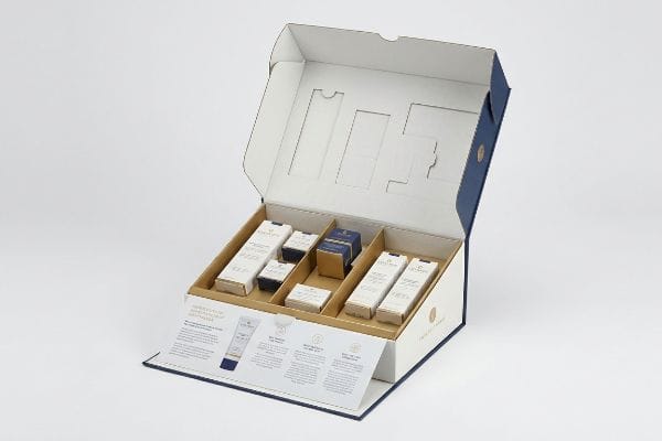 Sothys Custom Display Box An open custom retail display box for Sothys Paris skincare, showcasing die-cut structural modifications, blue and white packaging, and multiple product compartments.