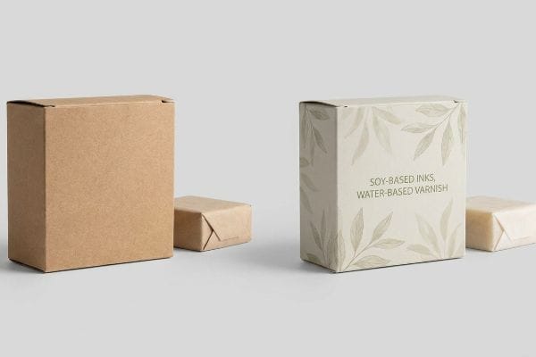 Brown kraft and leaf-patterned boxes with "Soy-Based Inks, Water-Based Varnish" text, demonstrating eco-friendly soap packaging.