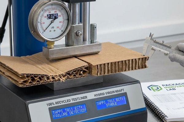 TAPPI T811 ECT compression test shows 100% Recycled Testliner failure at 212.5 lbs, Hybrid Virgin Kraft stable.
