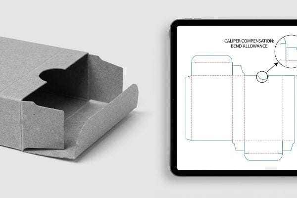 Tuck Box Dieline Compensation Gray paperboard tuck box, partially folded, beside a tablet showing a dieline with Caliper Compensation: Bend Allowance for accurate folding.