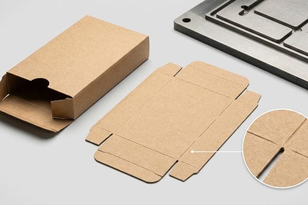 Tuck Box Die-Cutting Brown kraft paper tuck box, flat die-cut dieline, and metal die-cutting plate, with a magnified view of a precise scoring cut.