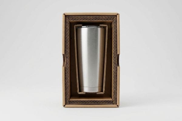 Tumbler Protective Packaging Stainless steel tumbler securely suspended in a corrugated cardboard box with a die-cut E-flute insert, showcasing protective suspension void packaging.