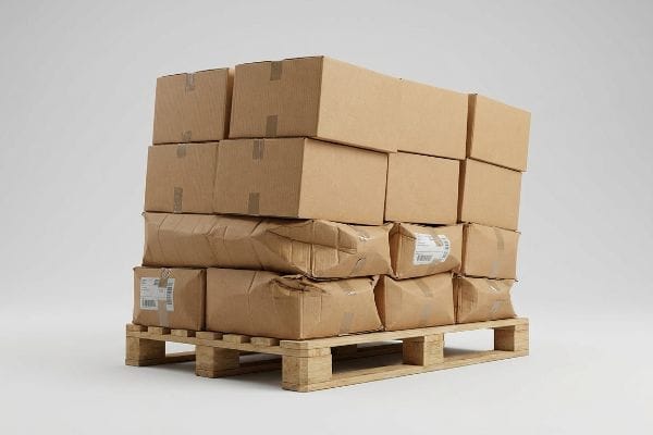 Brown corrugated shipping boxes and packages stacked on a wooden pallet, showing signs of wear from logistics.