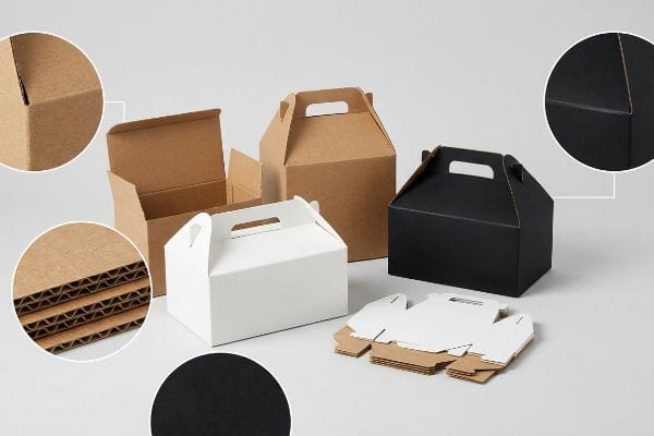 Eフルート段ボール、白紙板、黒クラフト紙のゲーブルボックス。素材の層構造と耐擦傷性仕上げのクローズアップ写真付き。.
