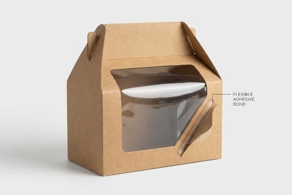 Caixa de cartão kraft castanho com formato de gable e janela transparente que exibe uma ligação adesiva flexível.