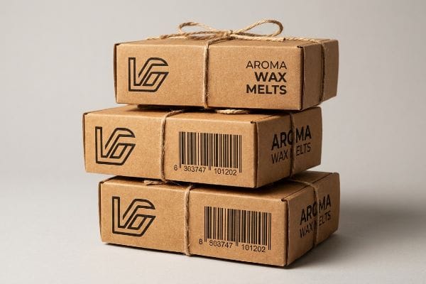 Vg Aroma Wax Melts Kraft Boxes Stacked kraft boxes for Aroma Wax Melts, tied with twine, display black VG logos and barcodes on unsealed paper.
