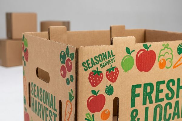 Brown corrugated produce bin with vibrant UV digital printing of Seasonal Harvest text, strawberries, apples, and blueberries, showcasing personalized packaging.